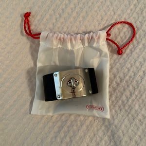 Iconic Coach black leather cuff bracelet.